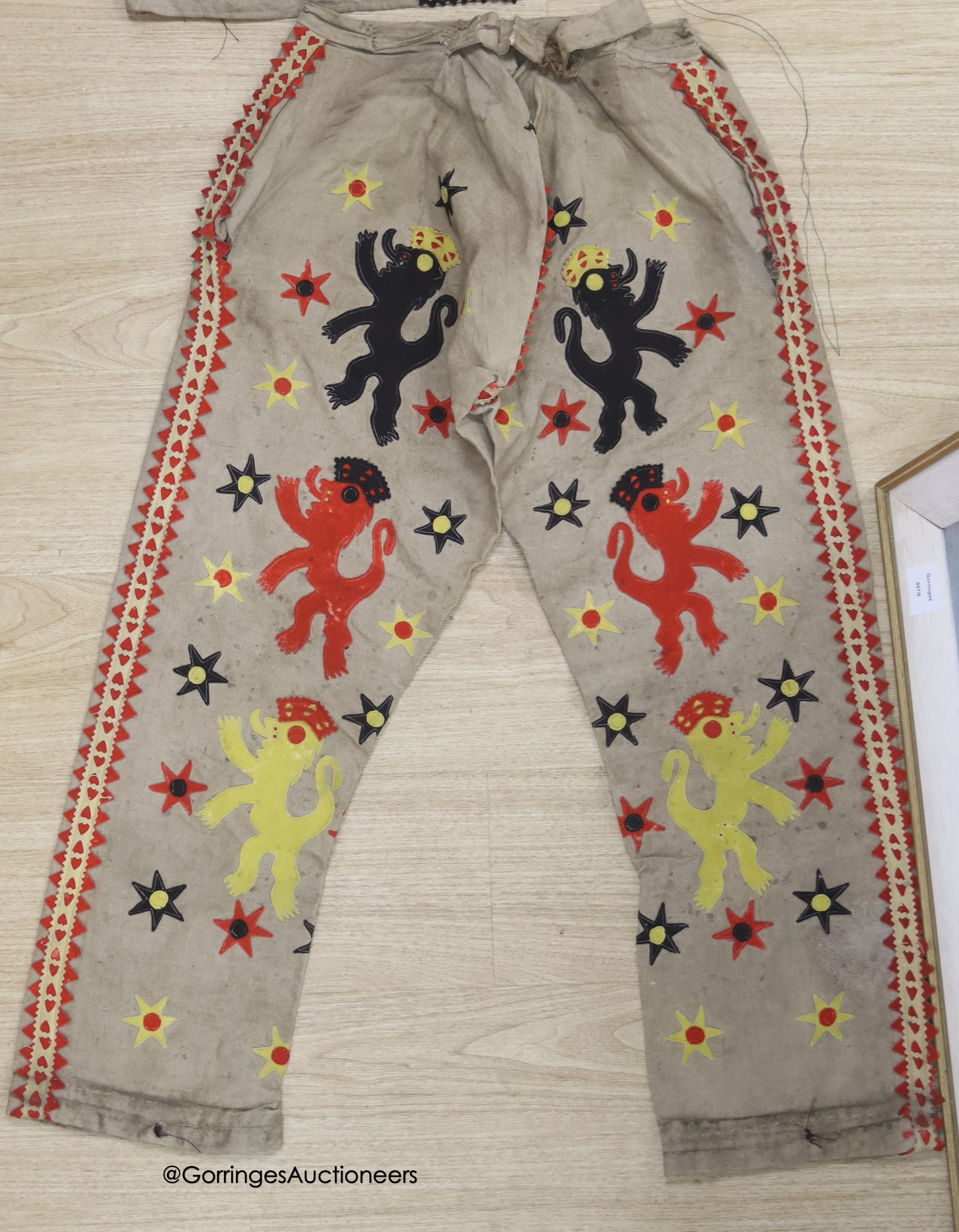 A coloured felt jacket and trouser set, jacket 68cm high